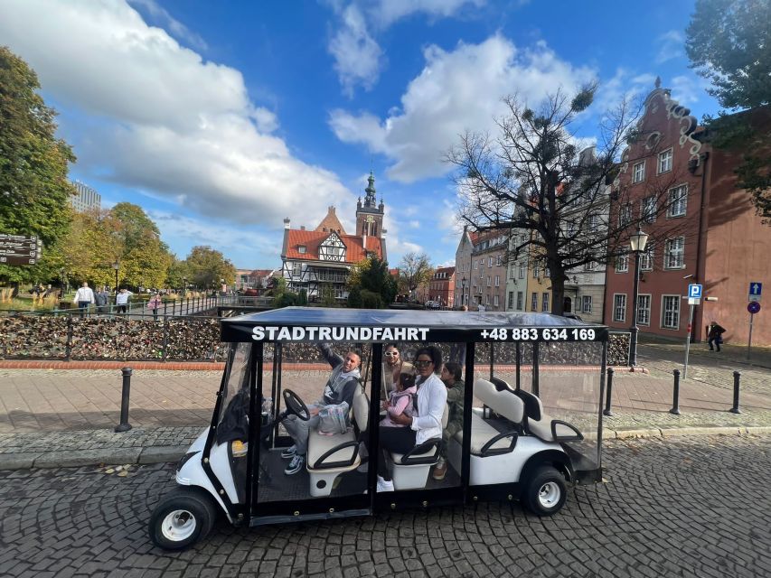 Gdansk: City Tour Live Guided by Golf Cart/Buggy Sightseeing - The fun, quirky stops: carousel and market hall moments