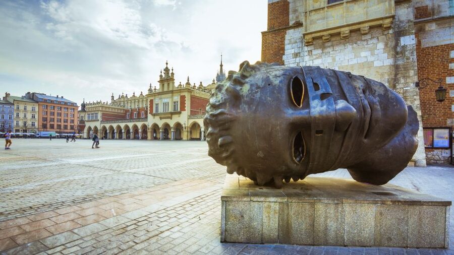 Krakow: Old Town Audioguided walking Tour - The first building with electricity and the return to Grodzka