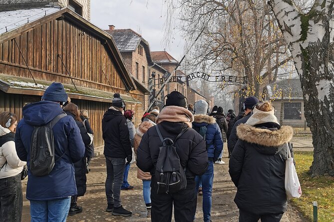 Krakow to Auschwitz Birkenau Guided Tour with Transfer and Ticket - Auschwitz I: the gate story, wooden buildings, and the meaning of Arbeit Macht Frei